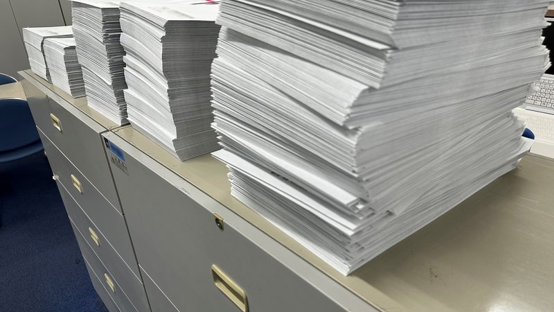 書類が積み上がった事務のデスク